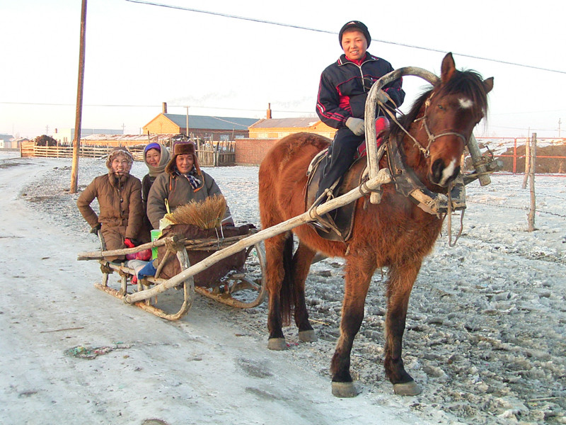 馬そりで移動する家族。最近はバイクや自動車に取って代わられてしまいましたが、このような馬そりや馬車での移動もまだ行われていました。